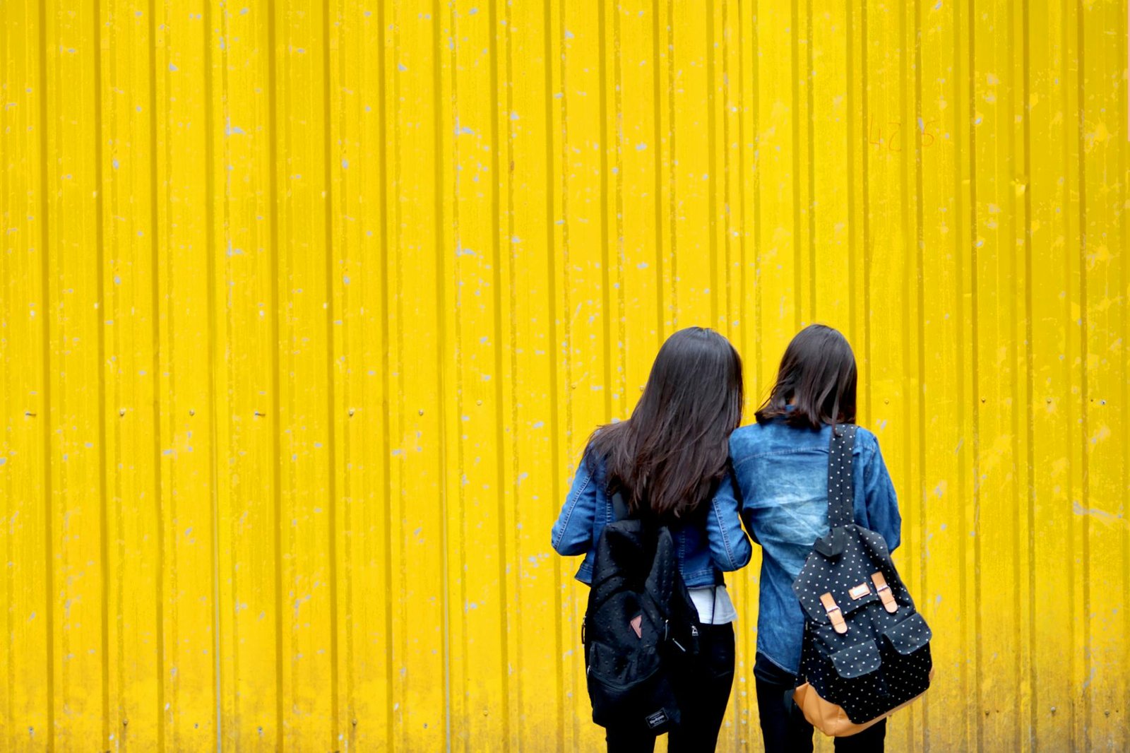 two women in denim jackets